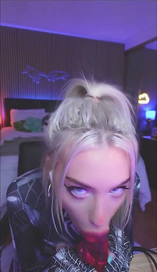 Who is this blonde cosplay girl giving a blowjob with a long tongue?'