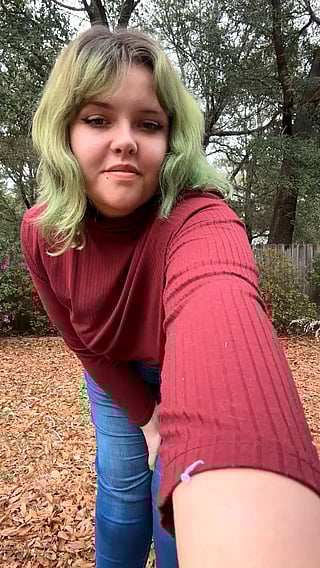 Watch this girl undress outside in the woods'