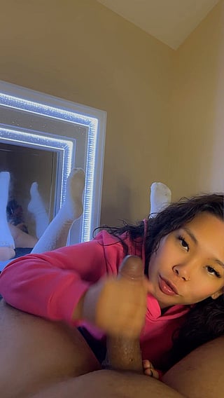 Asian Babe Gives Handjob to Big Dick'
