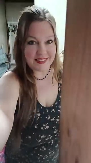 Chubby Lady Takes Selfie in Front of Wooden Door'