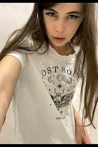 Cute Teen Takes Selfie in White Shirt with Skull Logo'
