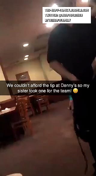 Sister tipping waiter at diner'