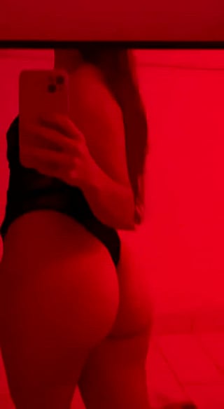 Teen girl takes selfie in red room'